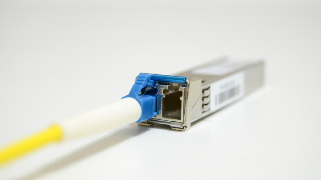 A close-up image of a transceiver at the end of a networking cable